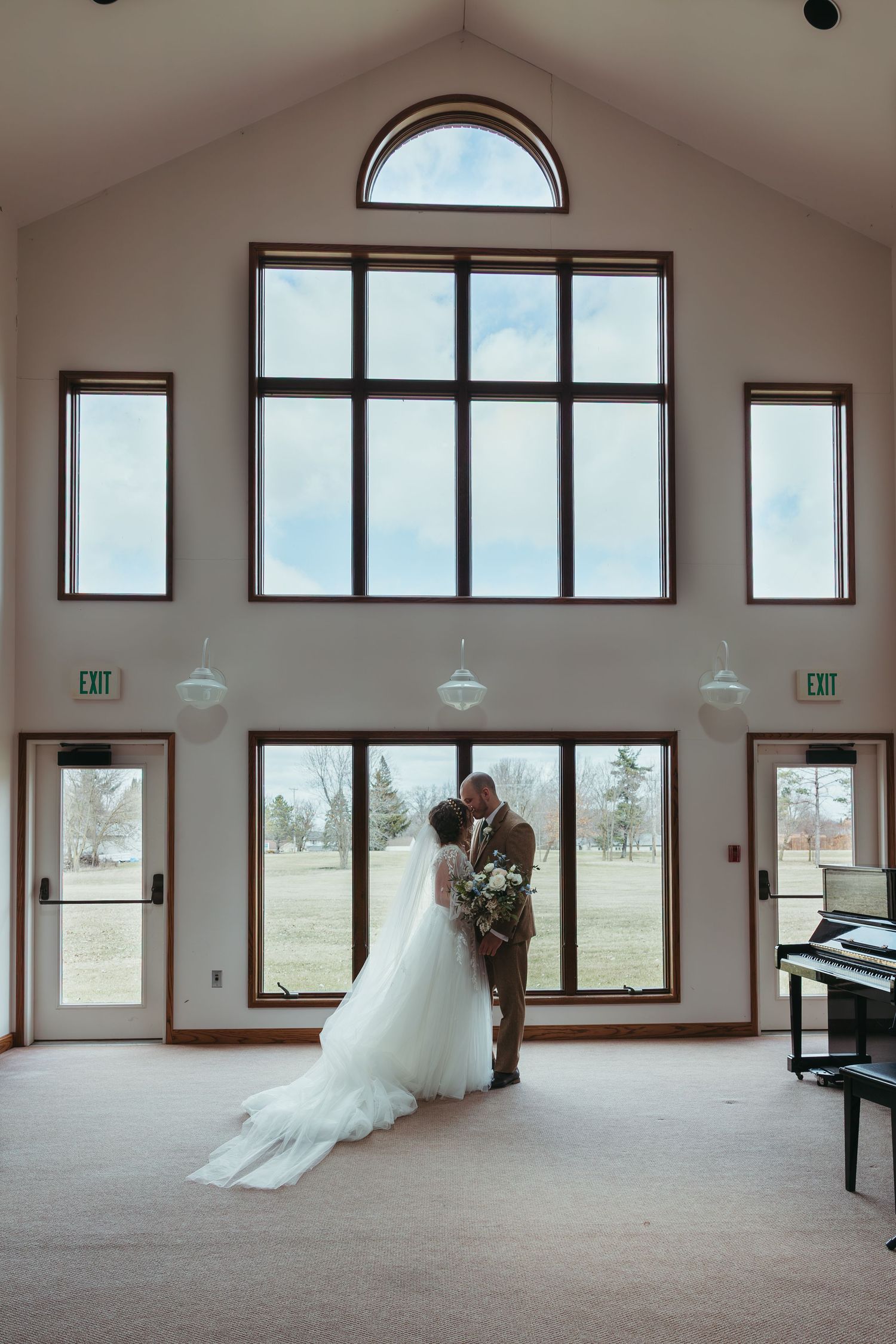 Bride and groom embracing during a March wedding in Indiana with soft early spring light.