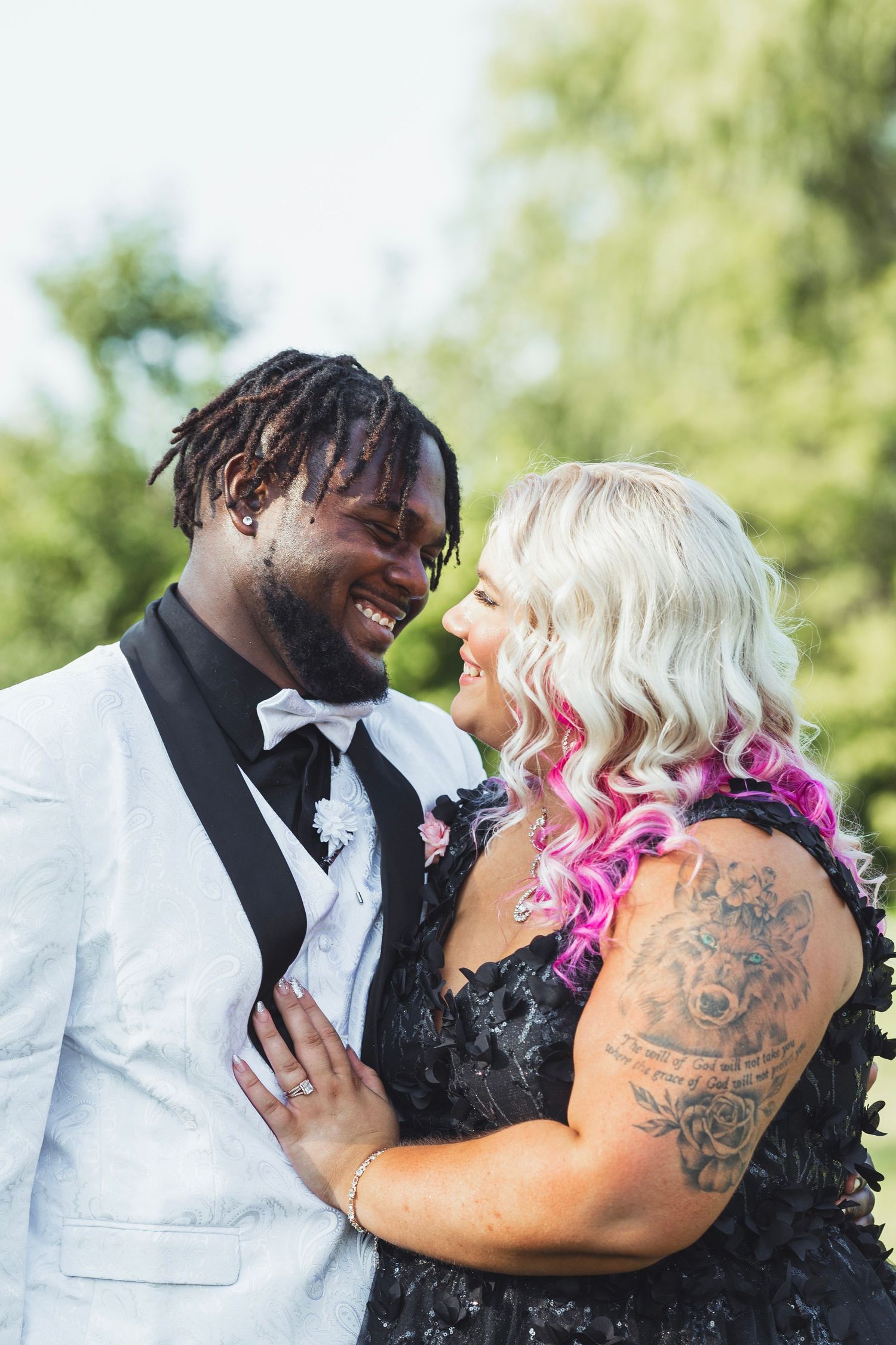 Intimate Flint Michigan wedding couple portrait captured outdoors with the couple embracing in natural light