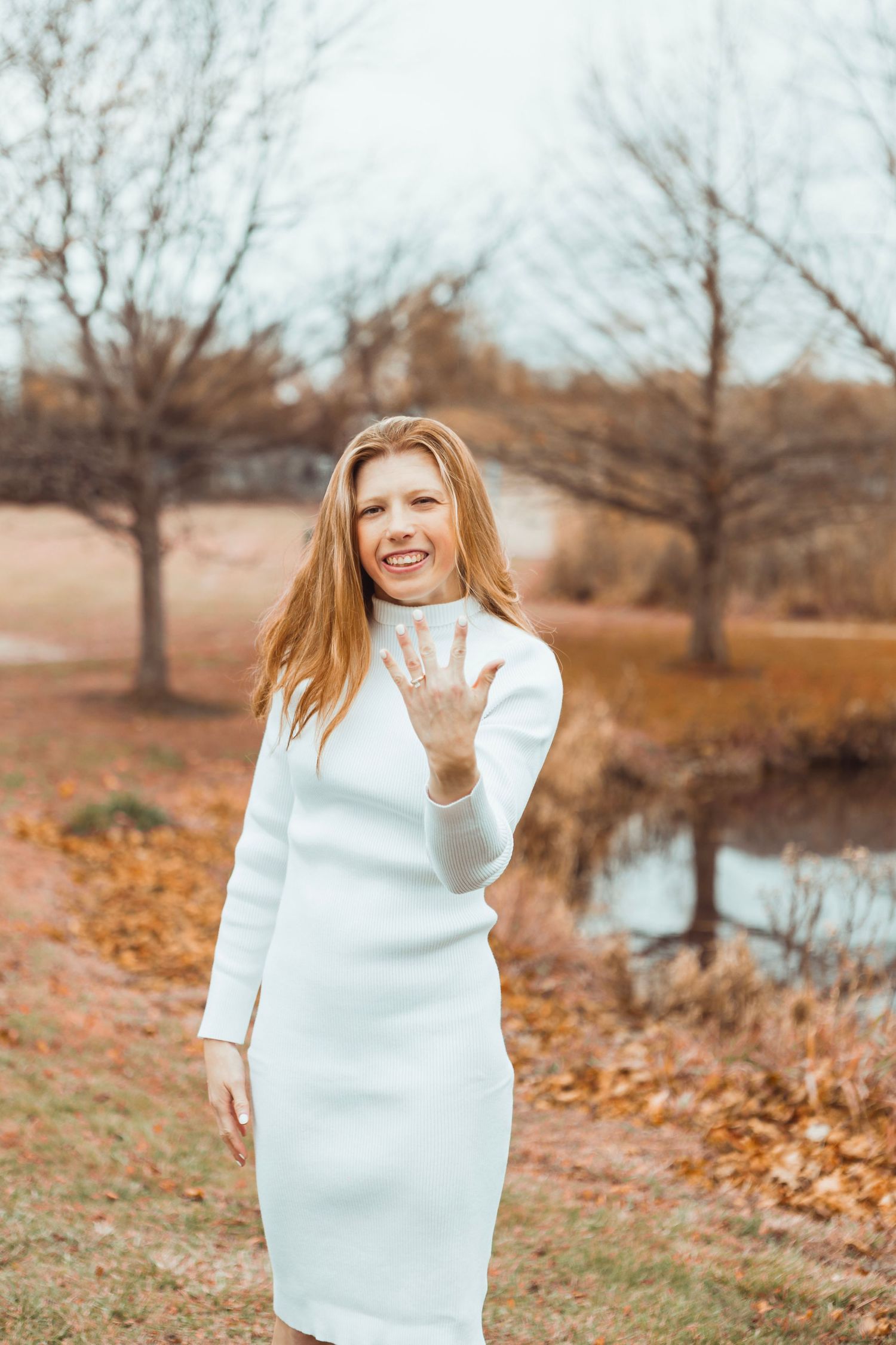 Close-up engagement photo in Oakland County, Michigan showing the bride-to-be holding up her hand with an engagement ring