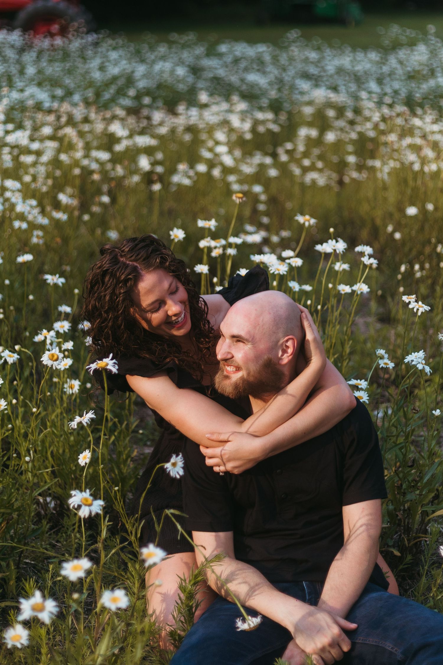 Couple embracing in a wildflower field during a family session with a Southeast Michigan photographer near Detroit.