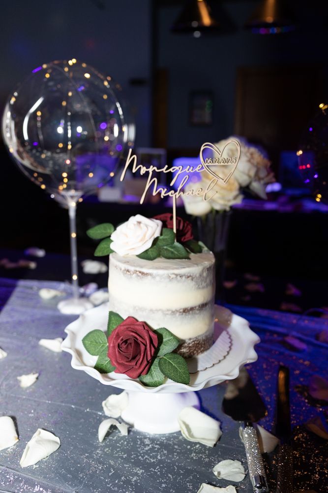 Wedding cake at a Michigan wedding reception photographed with on-camera flash for a clean, dramatic look