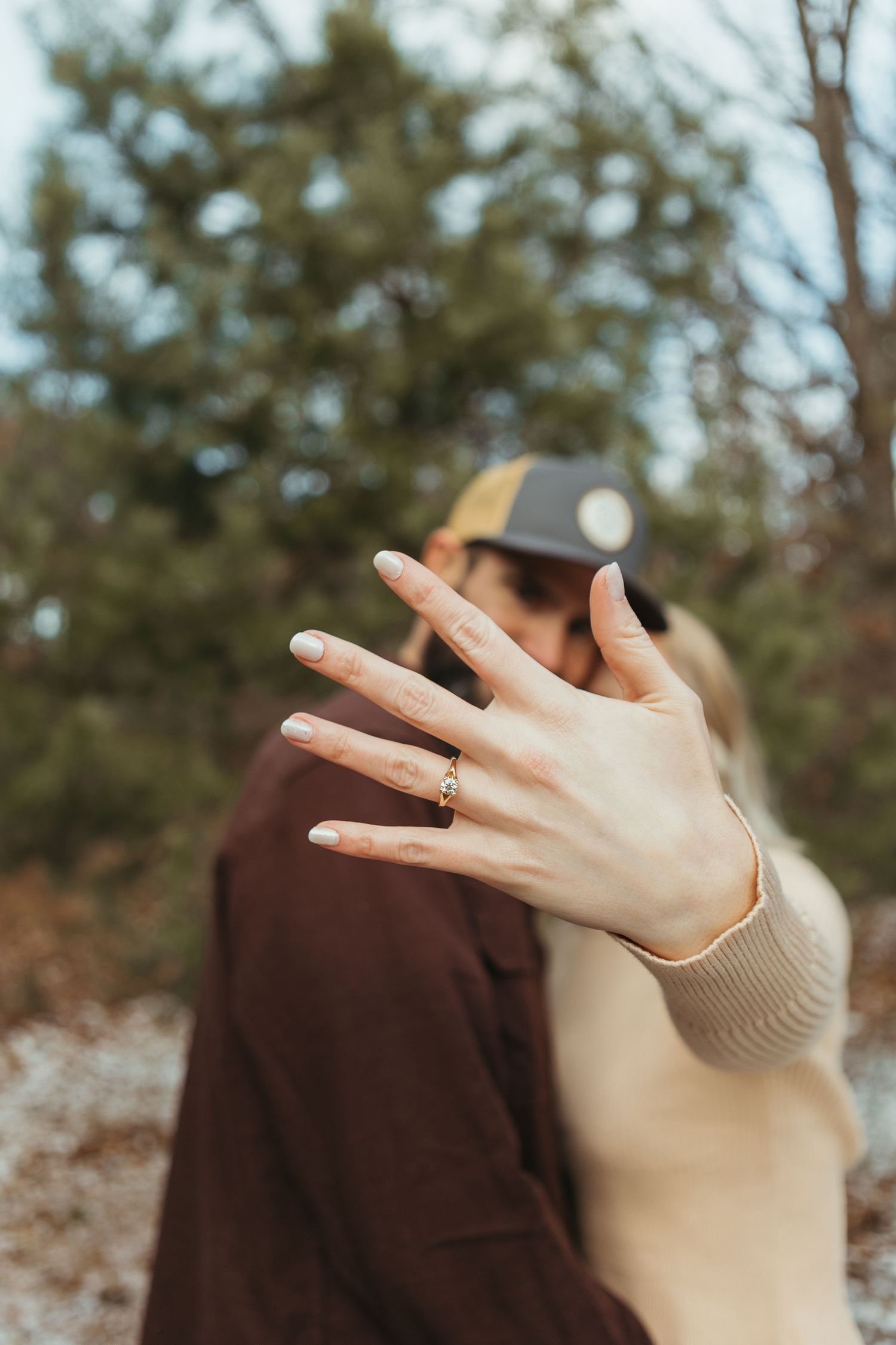 Winter engagement photo session in Lapeer, Michigan featuring a couple outdoors in a snowy natural setting