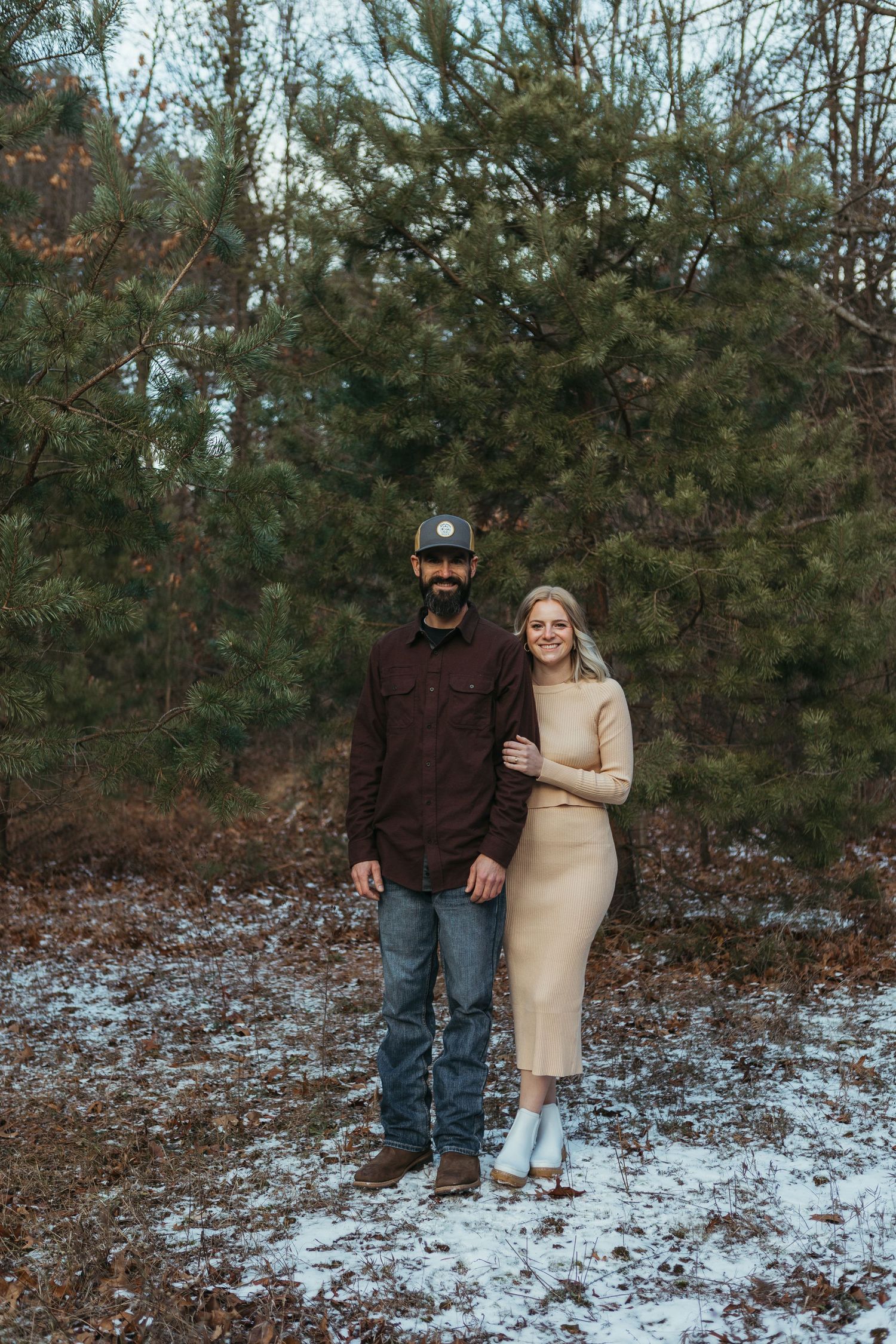 Winter engagement photo session in Lapeer, Michigan featuring a couple outdoors in a snowy natural setting
