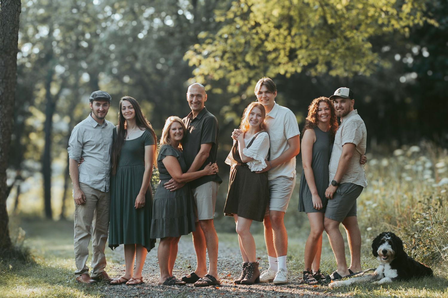Outdoor family photography session in Oakland County, Michigan featuring a multi-generation family on a wooded trail in natural light