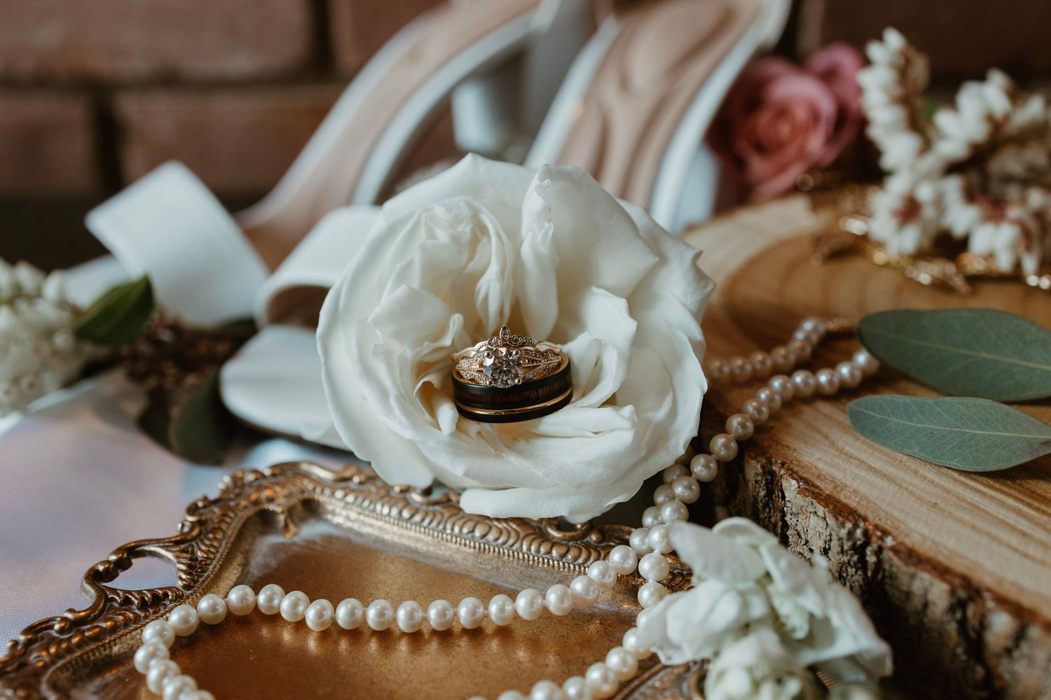 Wedding detail flat lay with rings and florals from a March wedding in Indiana.