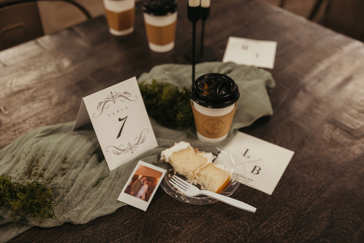 Wedding detail photography from a March wedding in Indiana showcasing late night details natural moss decor, polaroid's, wedding cake
