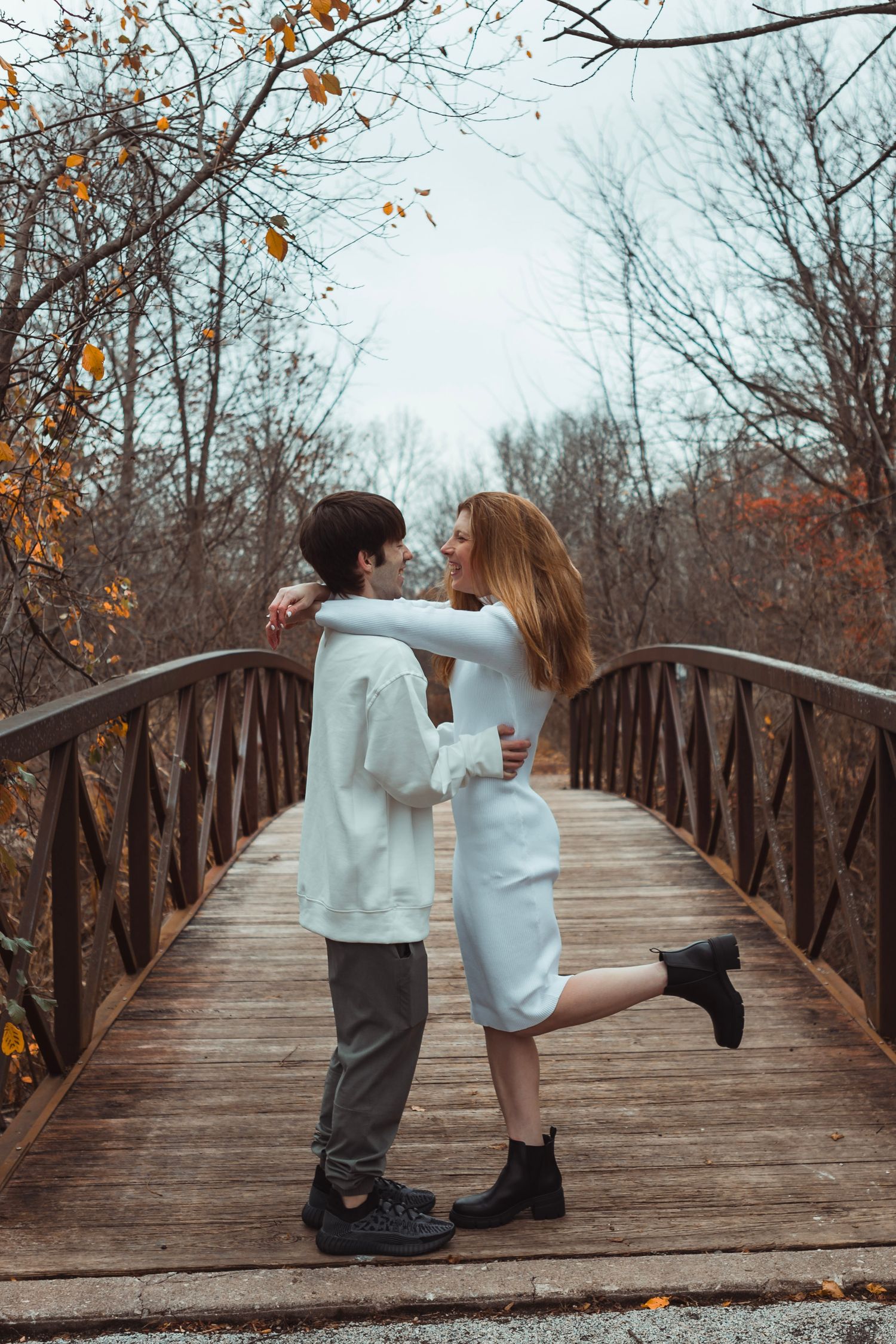 Outdoor fall engagement photos in Oakland County, Michigan captured in warm natural light
