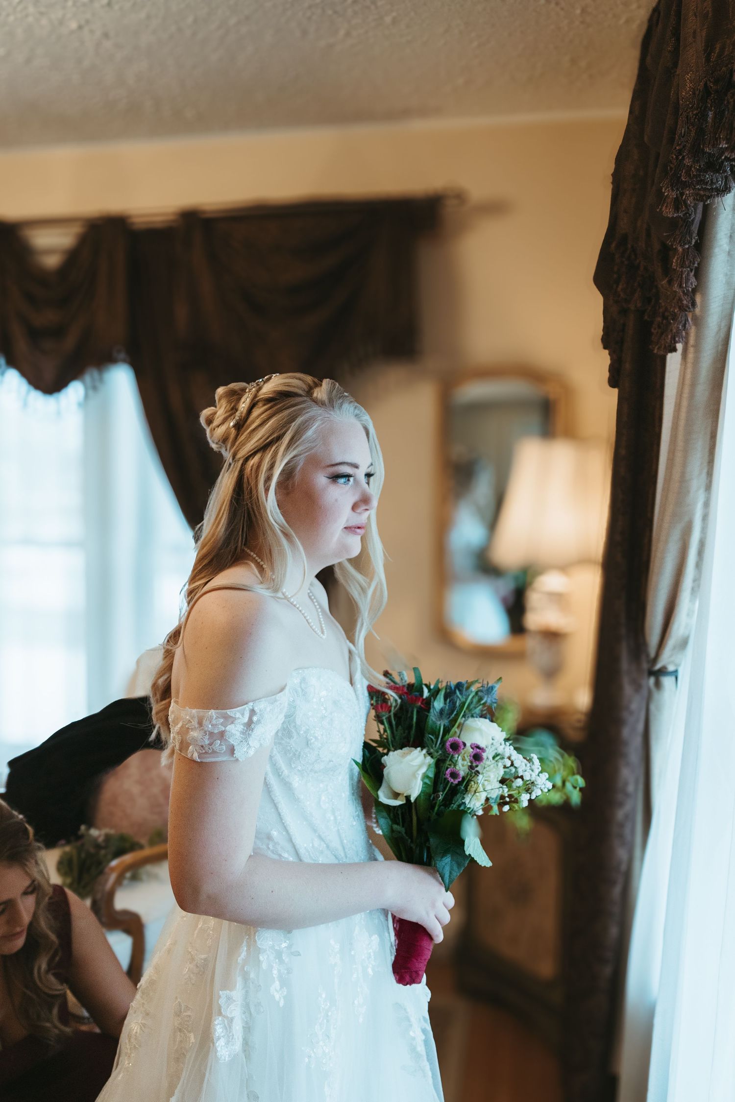 Bride  getting ready during a Michigan wedding in soft natural light