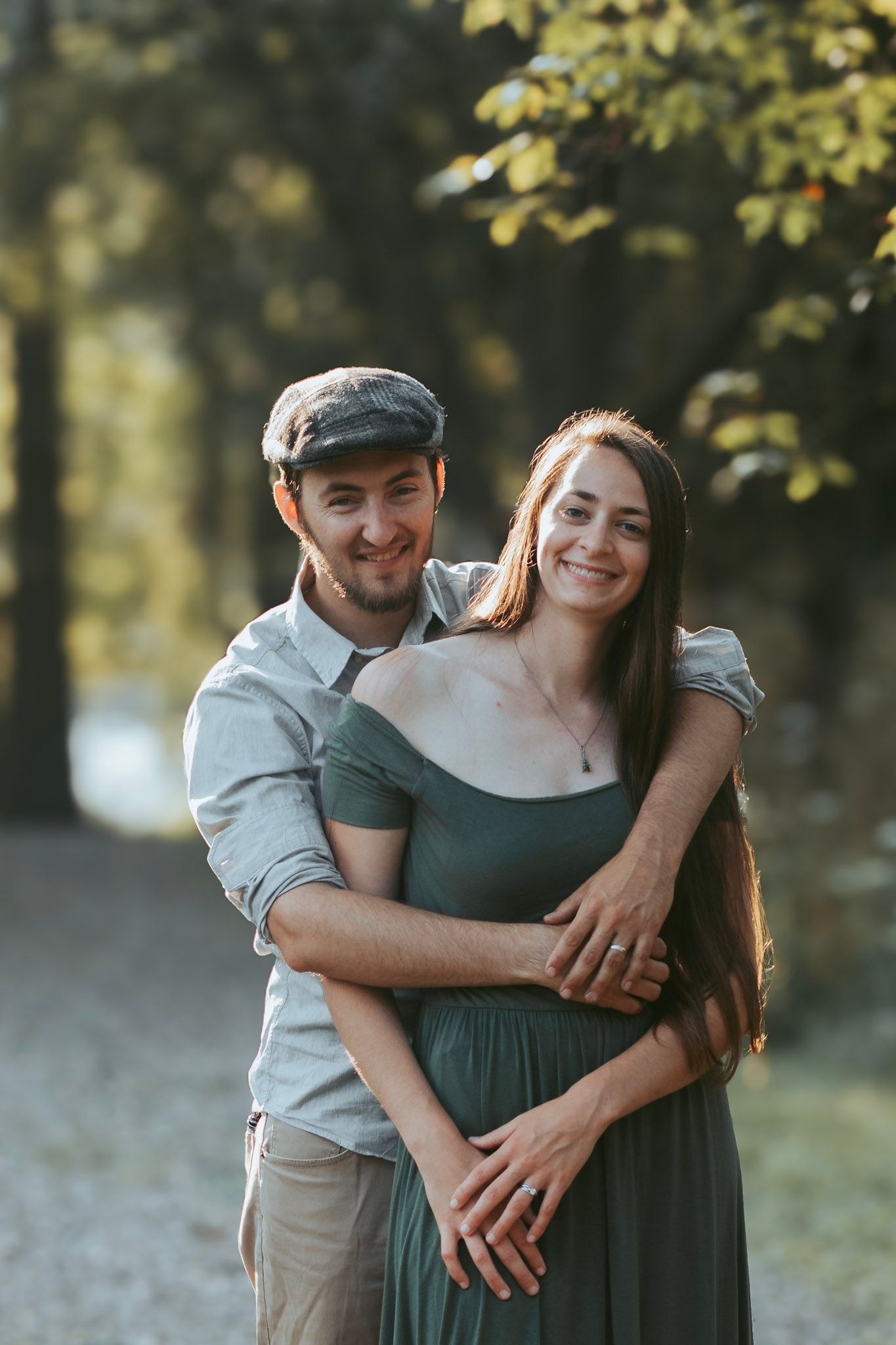 Outdoor couples portrait during an Oakland County family photo session featuring a couple standing together on a wooded trail