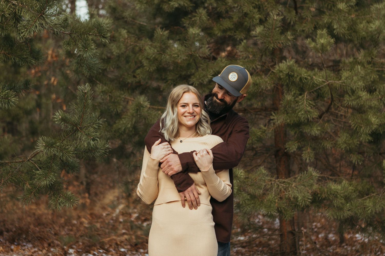 Winter engagement photo session in Lapeer, Michigan featuring a couple outdoors in a snowy natural setting