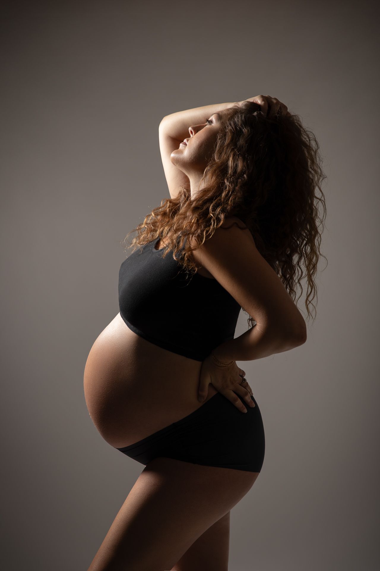 Elegant maternity photography in Oceanside CA studio capturing motherhood during pregnancy by portrait photographer