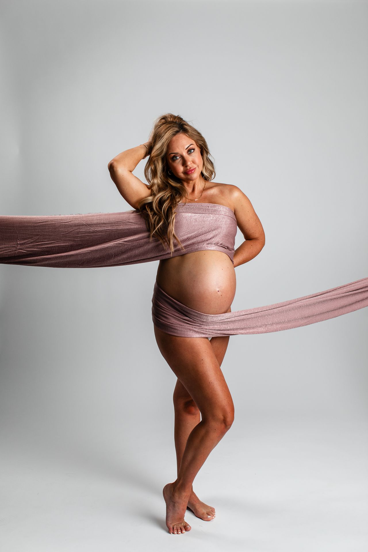 Studio maternity portrait in Oceanside CA capturing motherhood and pregnancy in light and airy photography style