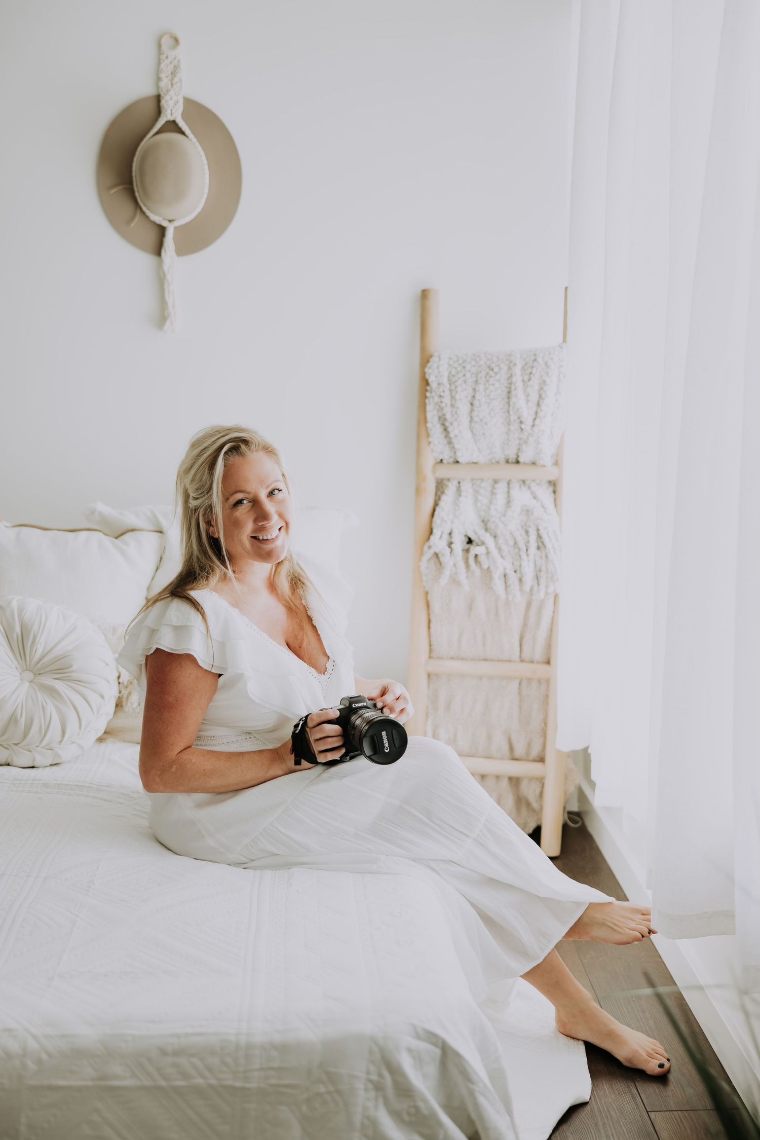 A series of bright white bedroom photos showing someone relaxing and laughing while holding a camera in bed.