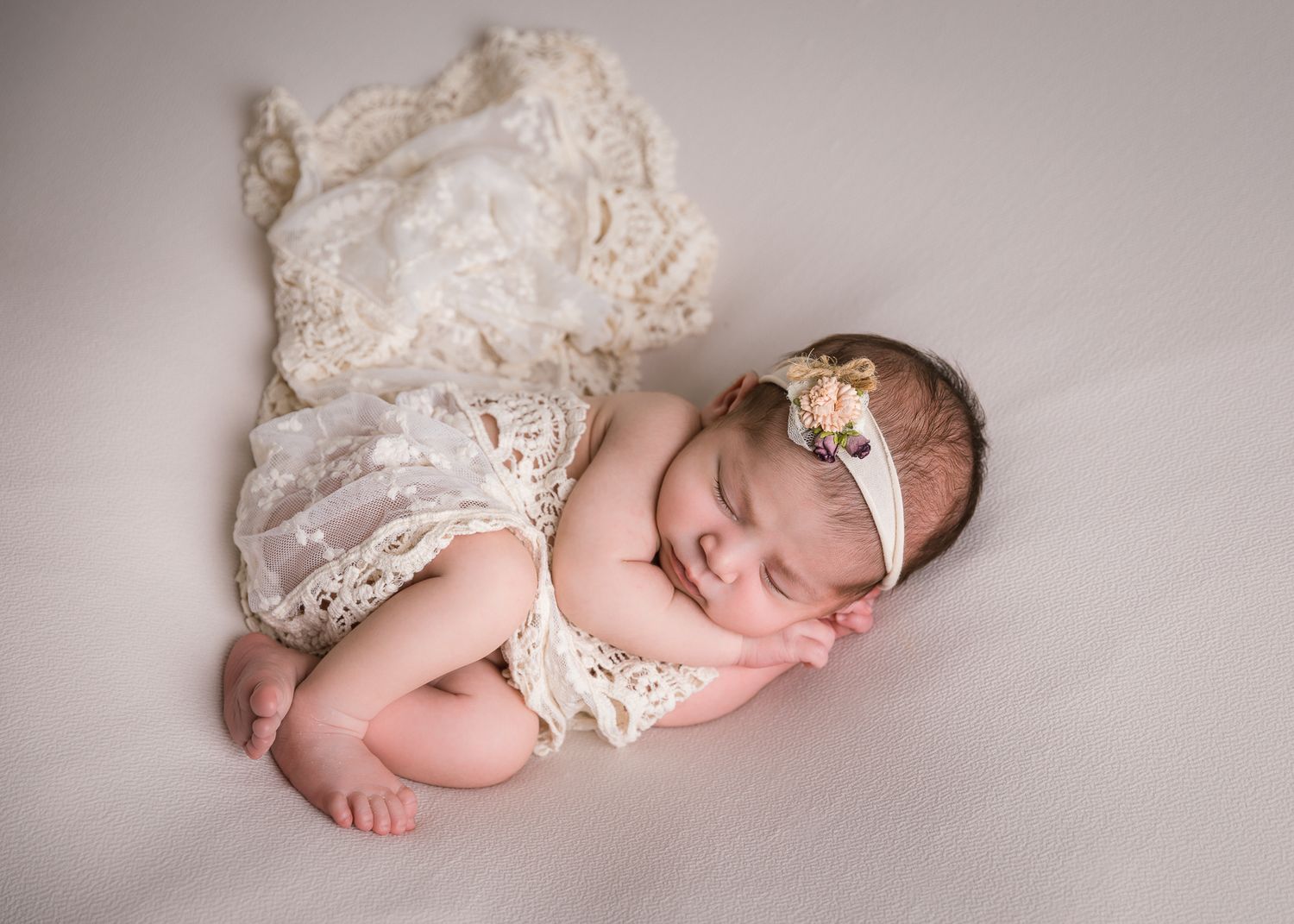 Professional newborn photographer in Vista CA capturing studio posed baby portraits in a private North County San Diego photography studio.