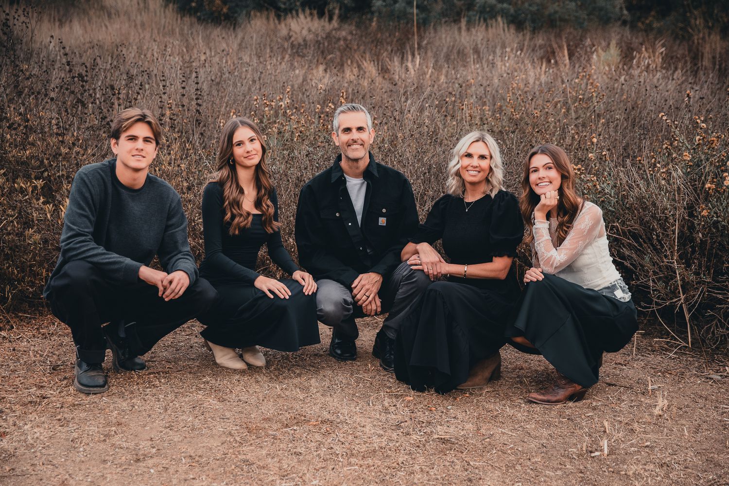 Family of five crouching together in front of dry brush in outdoor fall portrait, in Bonsall, near Fallbrook, & Temecula