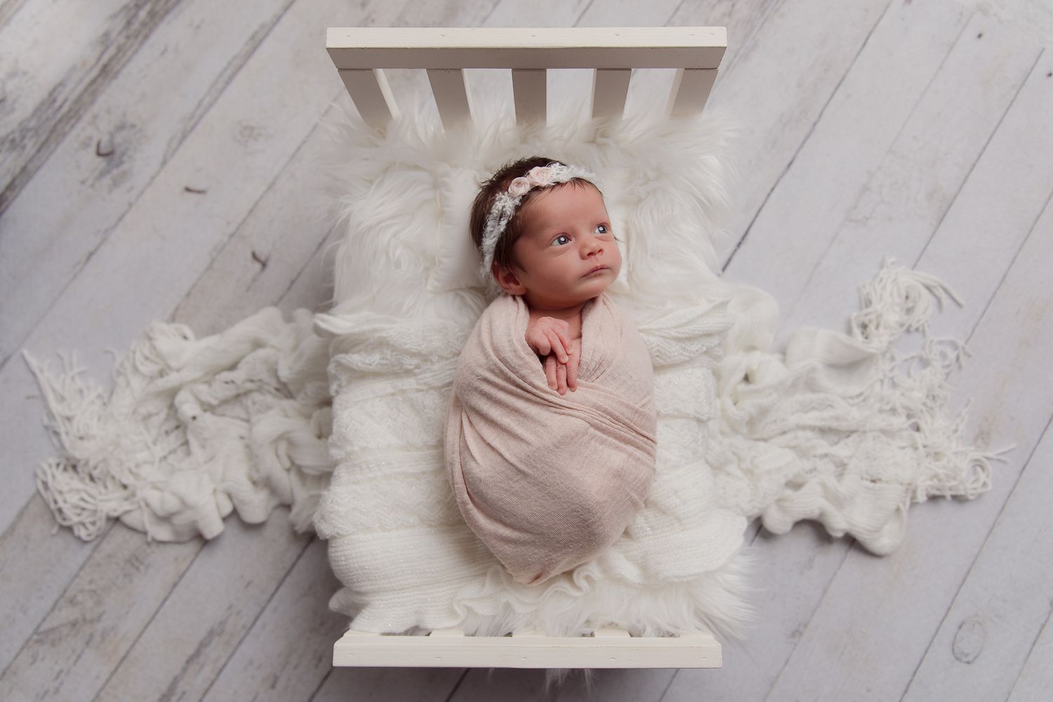 Fallbrook CA newborn photography studio offering posed baby portraits with wraps and props by Sarah Bracci Photographics.