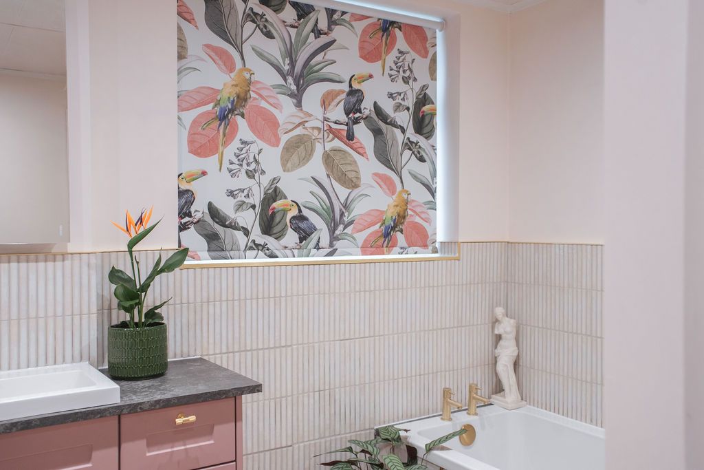Modern bathroom interior with floral wallpaper, white tile walls, and potted plants creating a spa-like atmosphere.