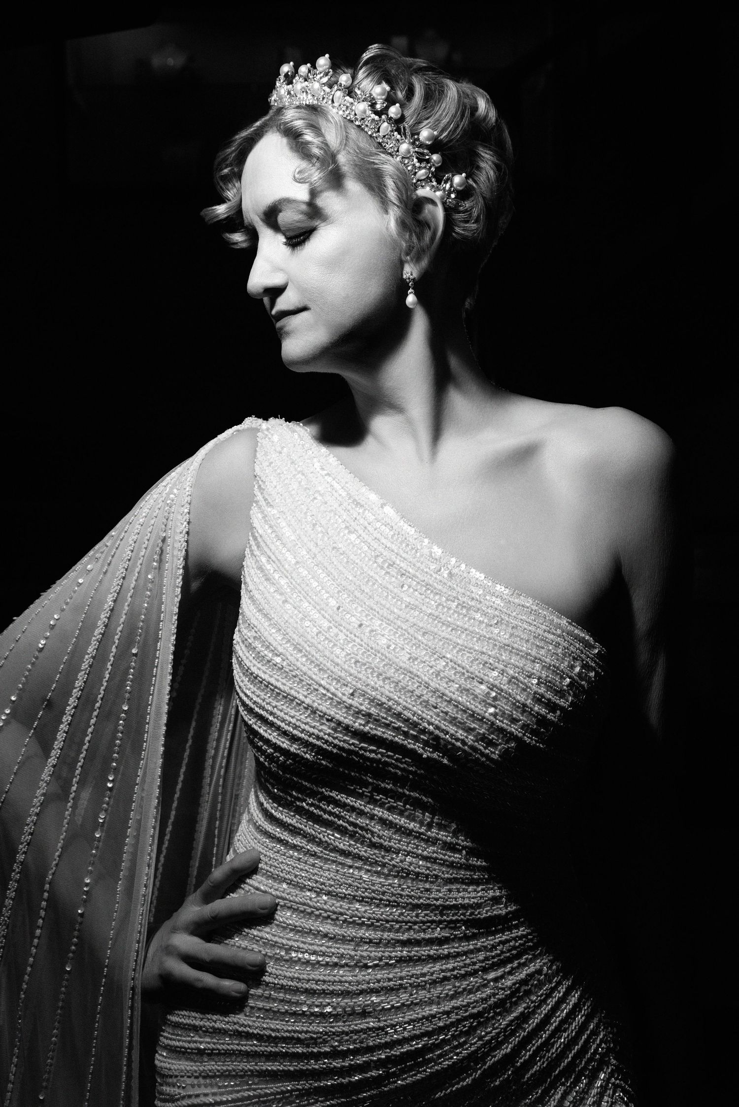 Glamorous black and white portrait featuring a one-shoulder beaded gown and sparkling tiara in vintage Hollywood style.