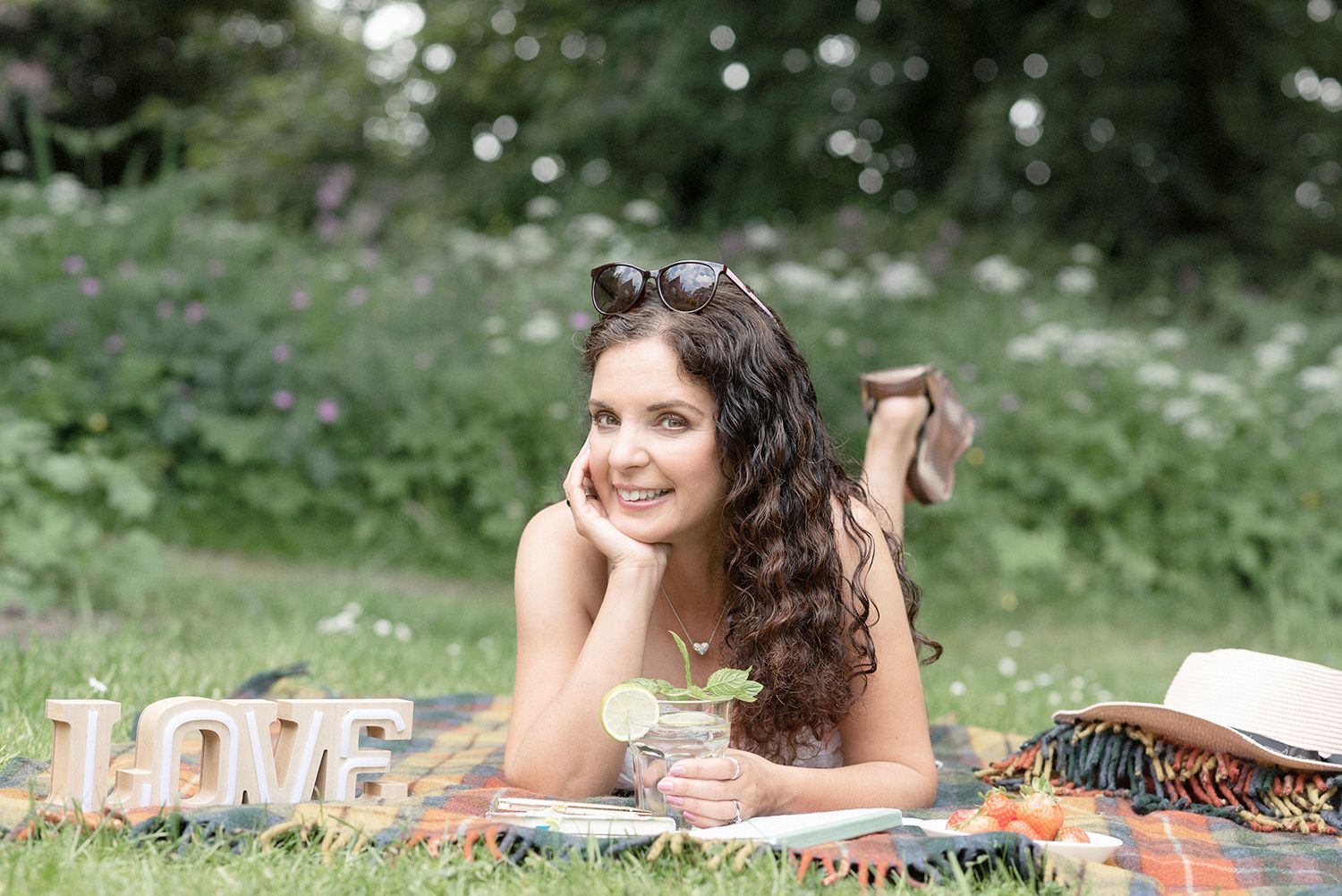 A series of outdoor portraits taken in a meadow with white flowers and natural lighting.
