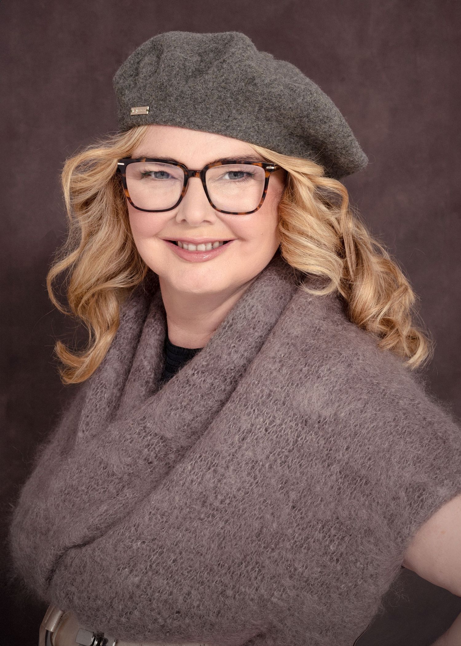 Cozy winter portrait featuring grey beret, glasses and matching scarf.