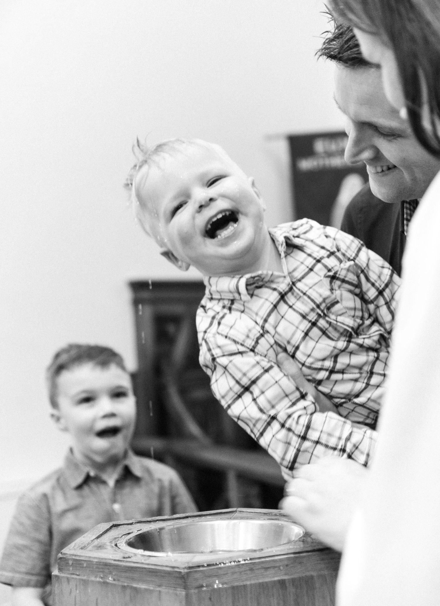 A series of black and white photos showing joyful laughter and genuine emotion in candid moments.