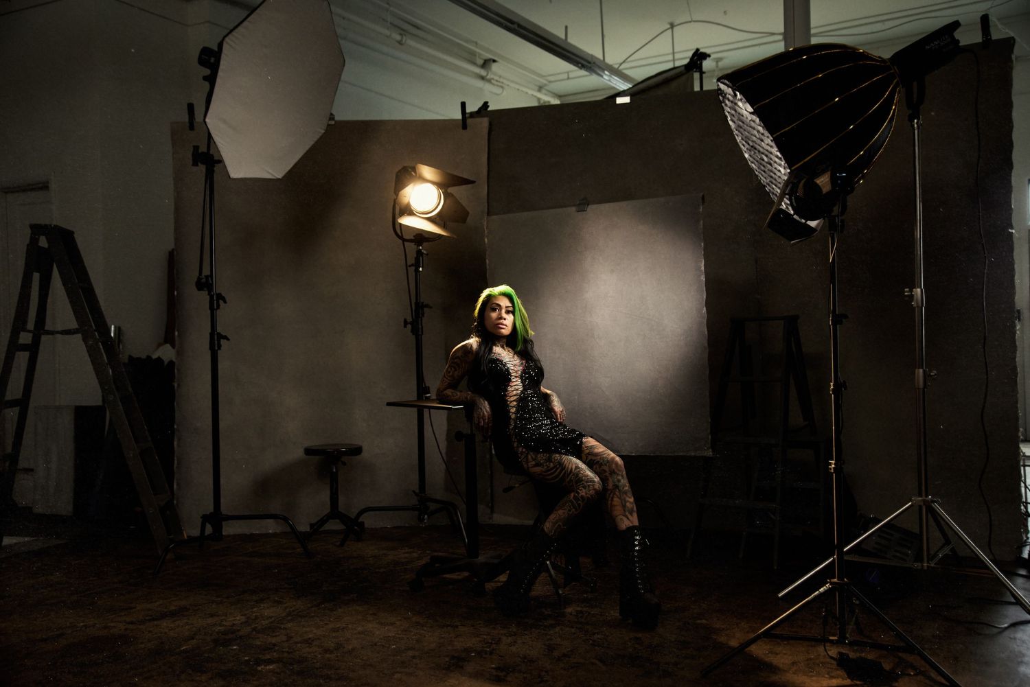 Behind the scenes studio photo shoot setup with lighting equipment visible.