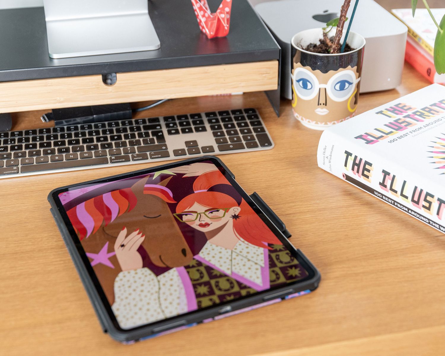 Closeup view of a computer keyboard and desk setup with colorful accessories and decorative items.