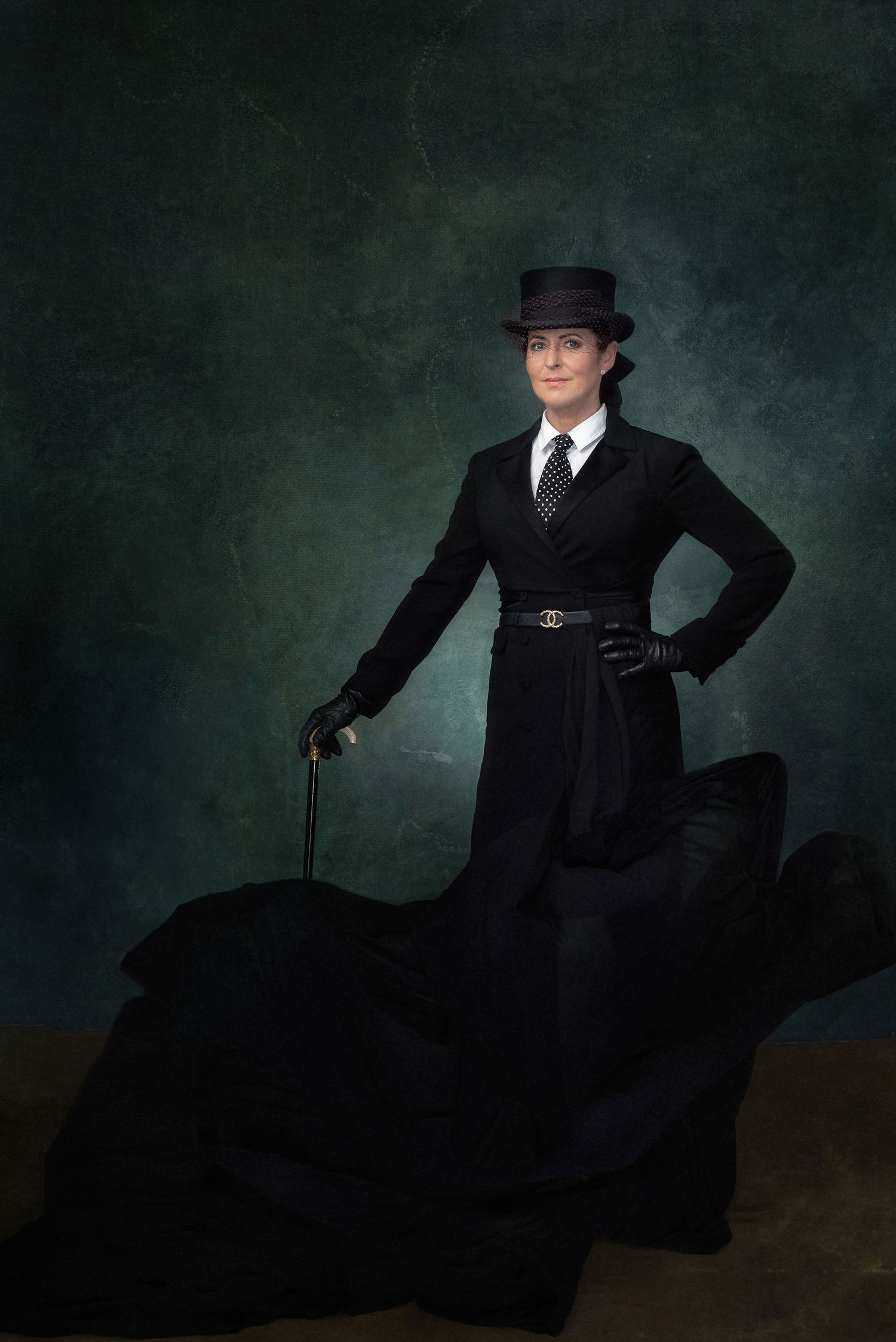 Victorian-style portrait with figure in black dress and top hat against dark green background.