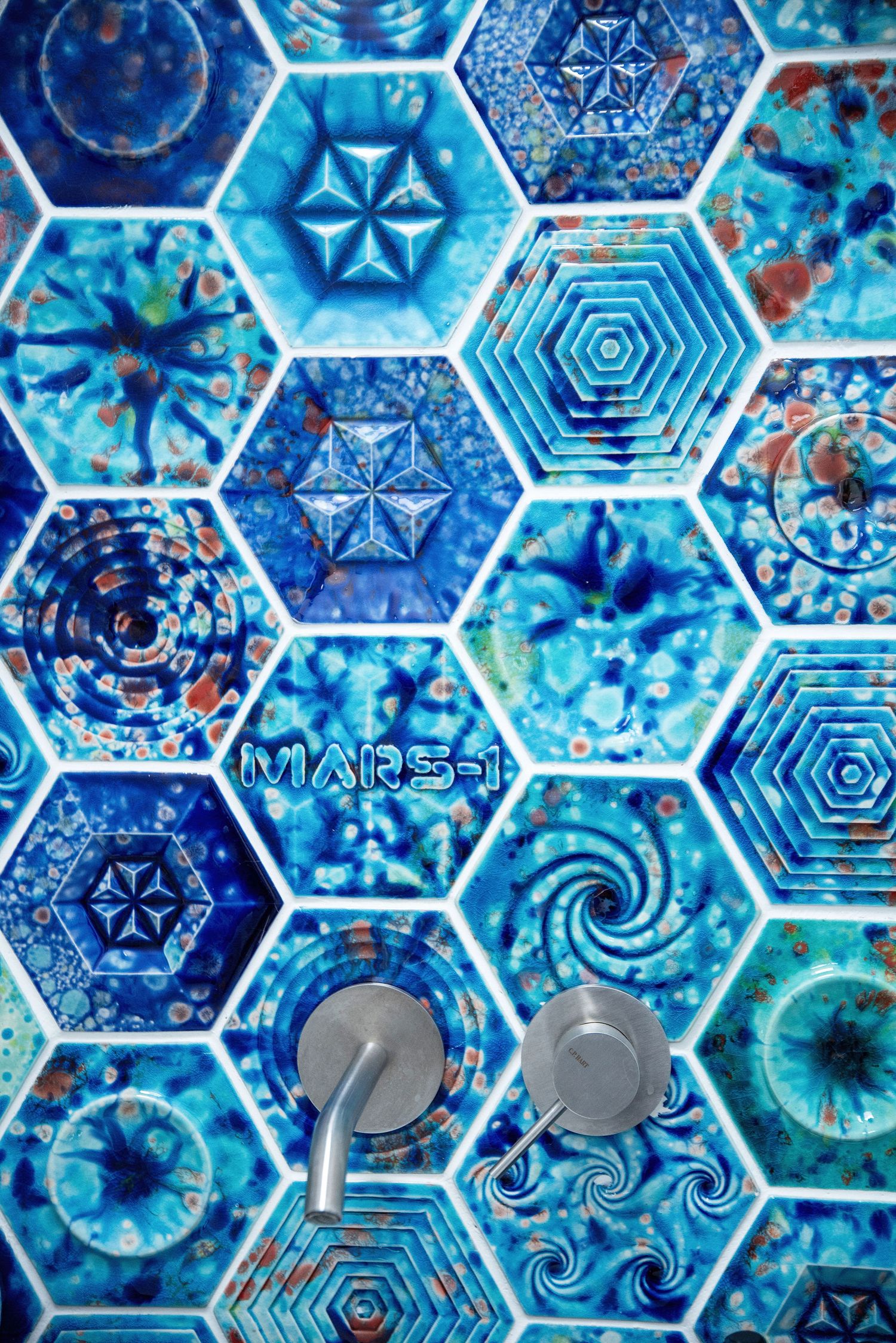 Abstract blue hexagonal pattern with kaleidoscopic designs featuring geometric shapes and swirling patterns in aqua tones.