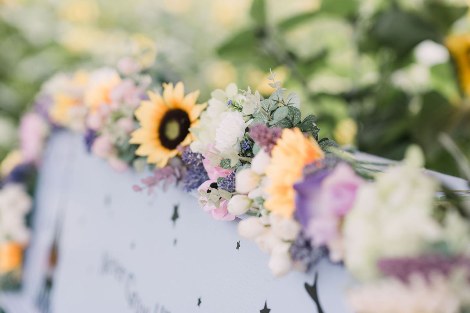 Delicate sunflower centerpieces brighten up a rustic dining table with a soft, dreamy glow.