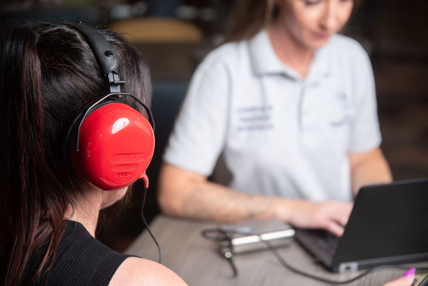 Student wearing red headphones during an educational assessment session.