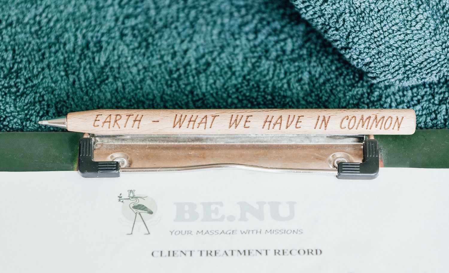 Wooden pencils and clinic paperwork against teal background.
