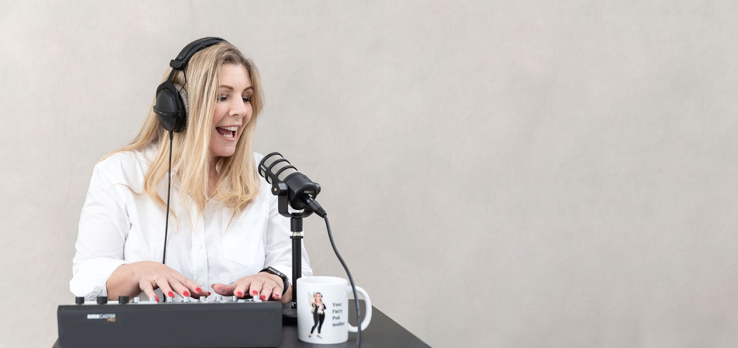 Broadcaster laughing while recording content at a podcast station with headphones.