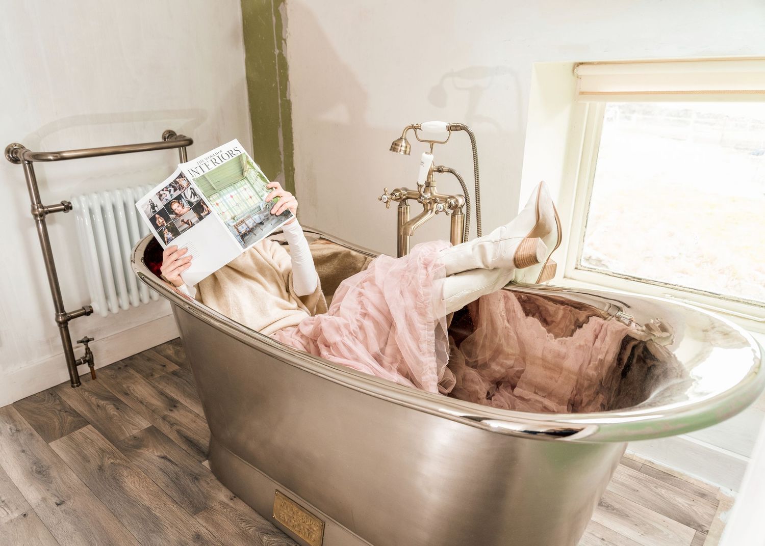 Series showing person relaxing in vintage clawfoot bathtub.