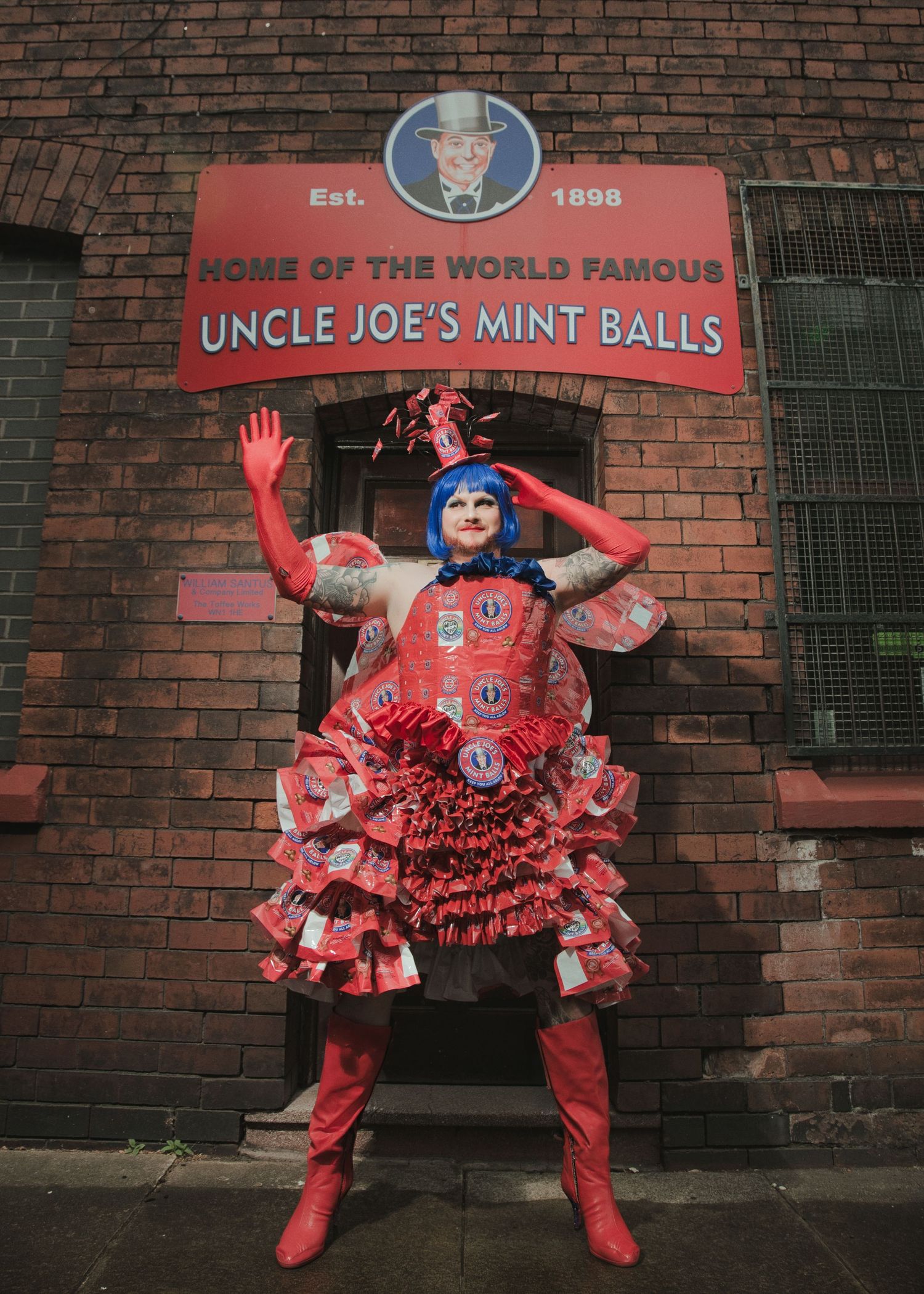 Person in red costume outside Uncle Joe's Mint Balls factory, Est. 1898, Wigan, UK.