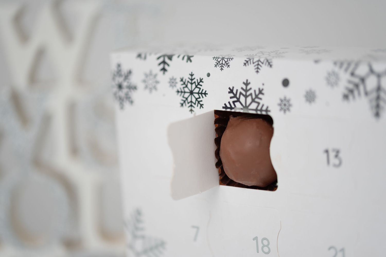 Advent calendar with snowflake design showing opened window.