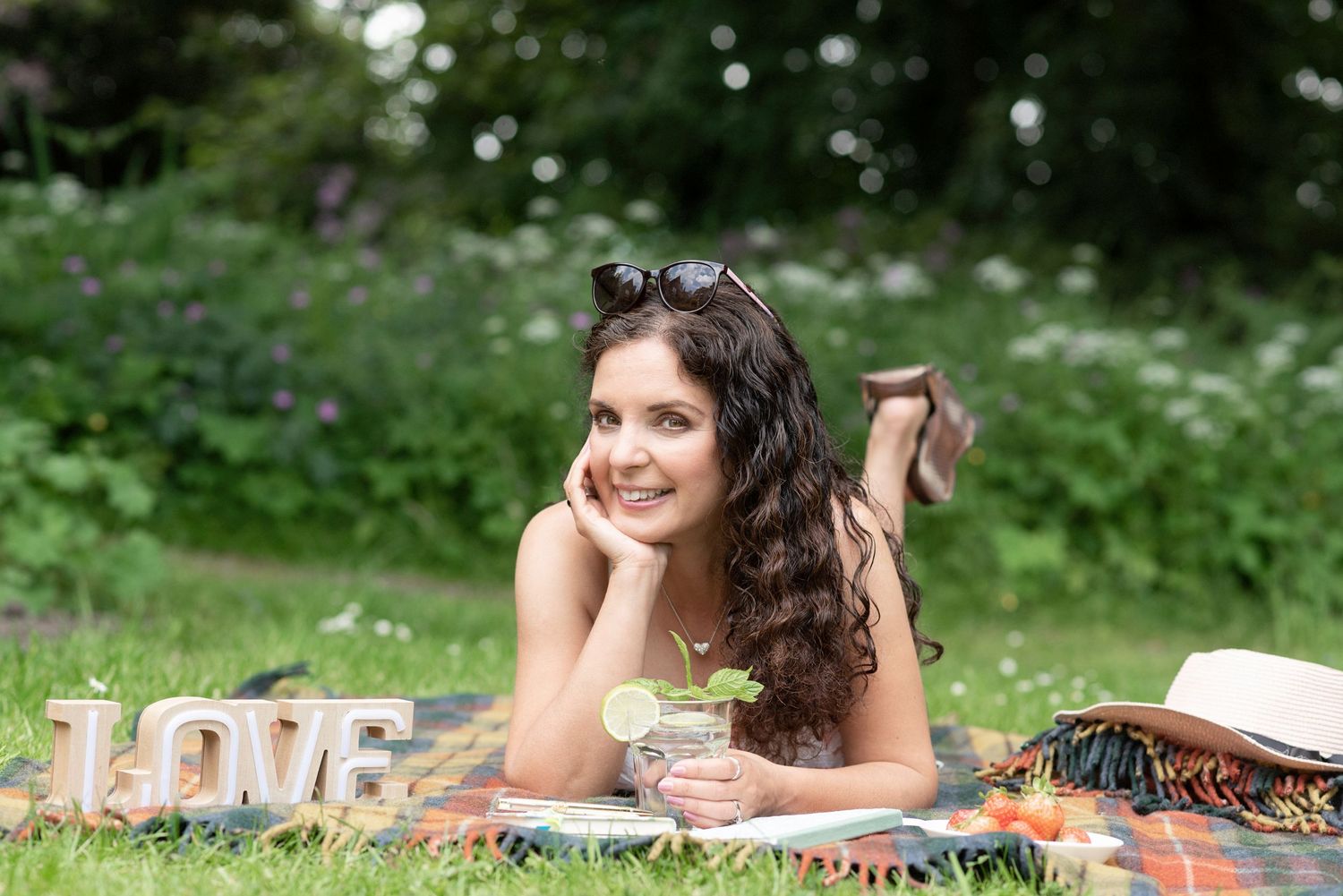 A summer outdoor photoshoot series in a field with daisies and natural lighting.
