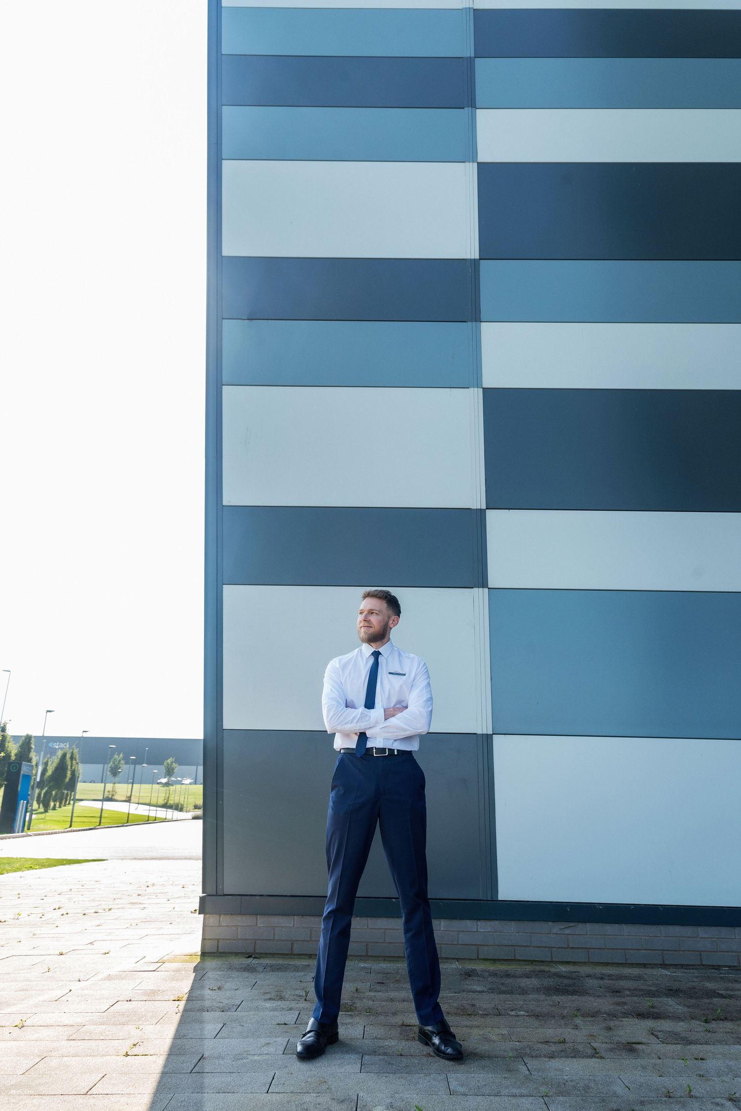 Environmental image of sales manager looking out from the hotel exterior