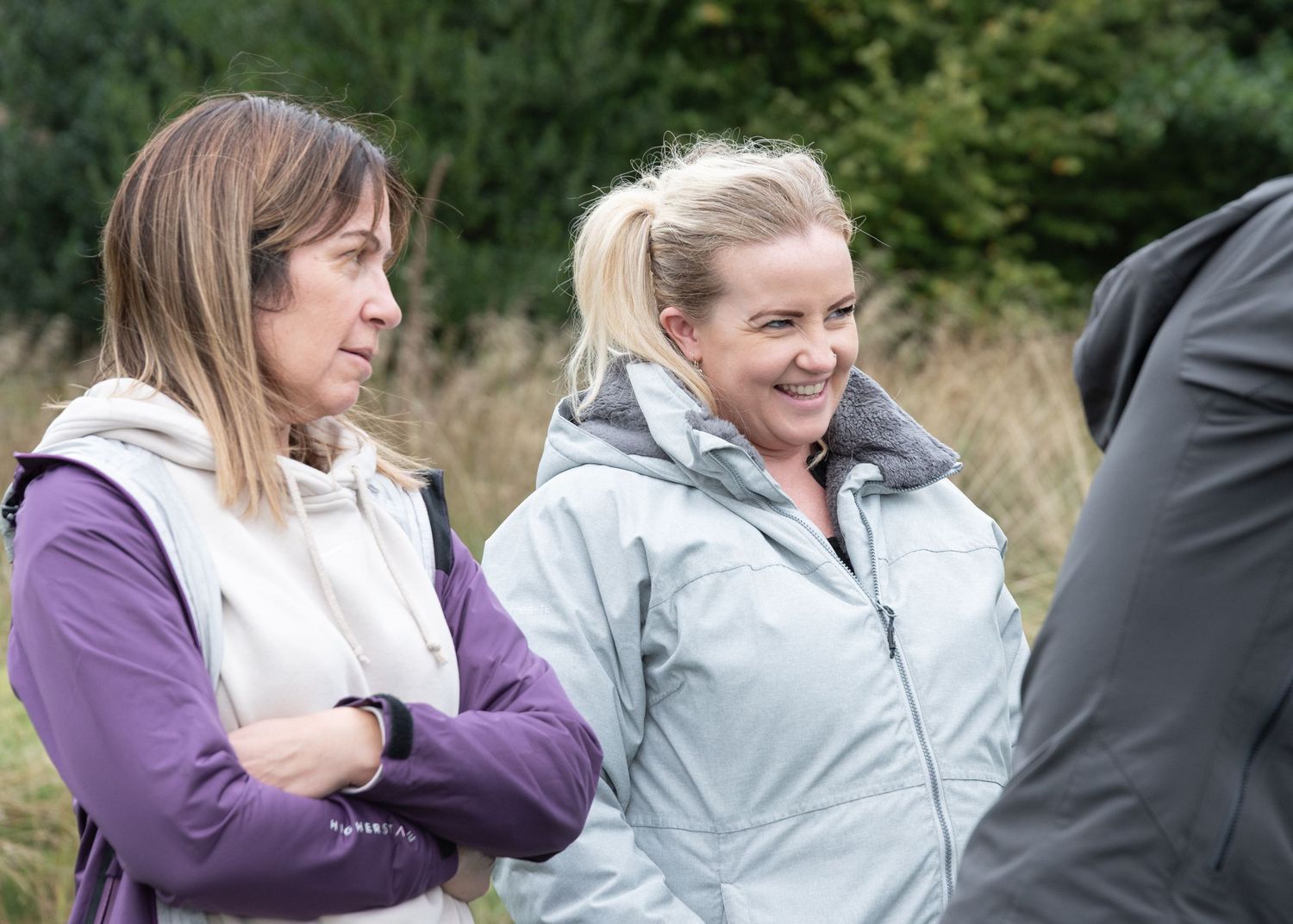 Four friends share moments of laughter and fun while enjoying themselves outdoors in natural surroundings.