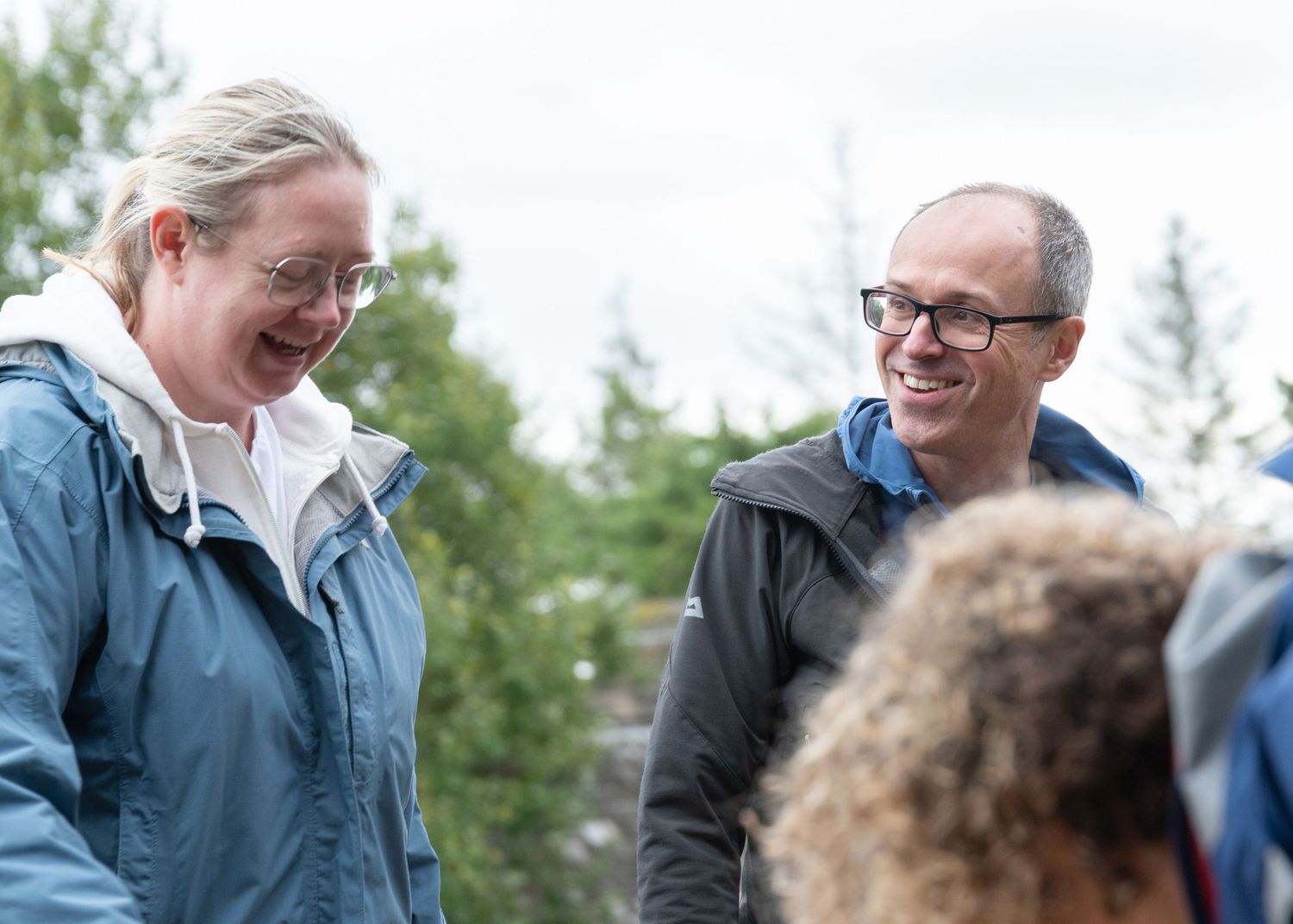 Sequence of casual outdoor interactions showing laughing and conversation between people in blue clothing.