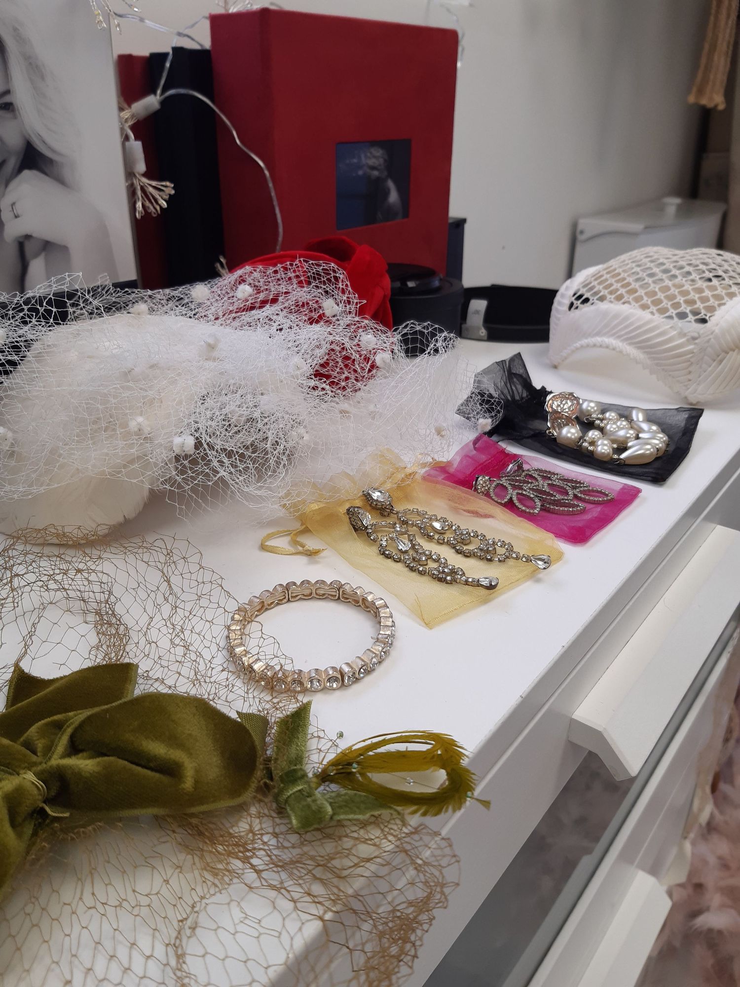 An assortment of bridal accessories including veils, jewelry, and headpieces displayed on a white surface.