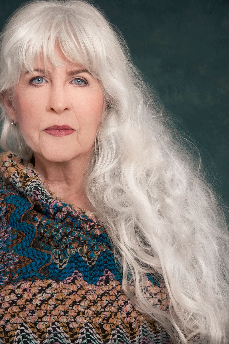 Close-up of attractive mature woman with long grey hair