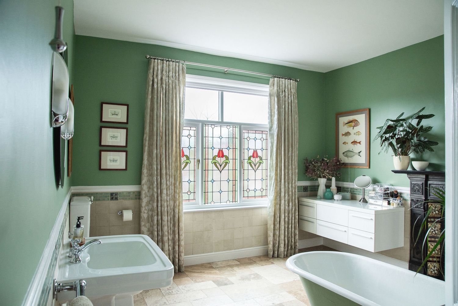 A panoramic view of a green-walled bedroom with floral curtains, windows, and natural lighting.