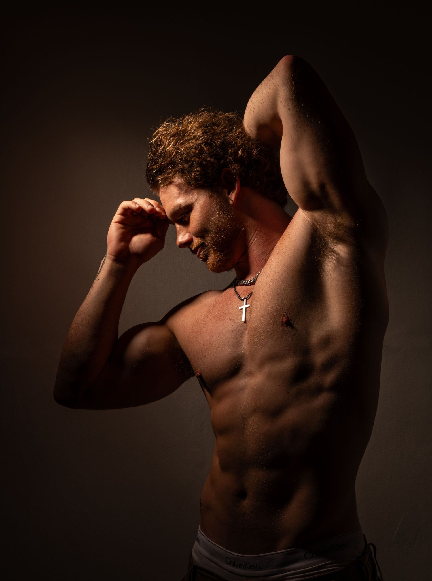 Artistic silhouette photos showing muscular physique against dark background.