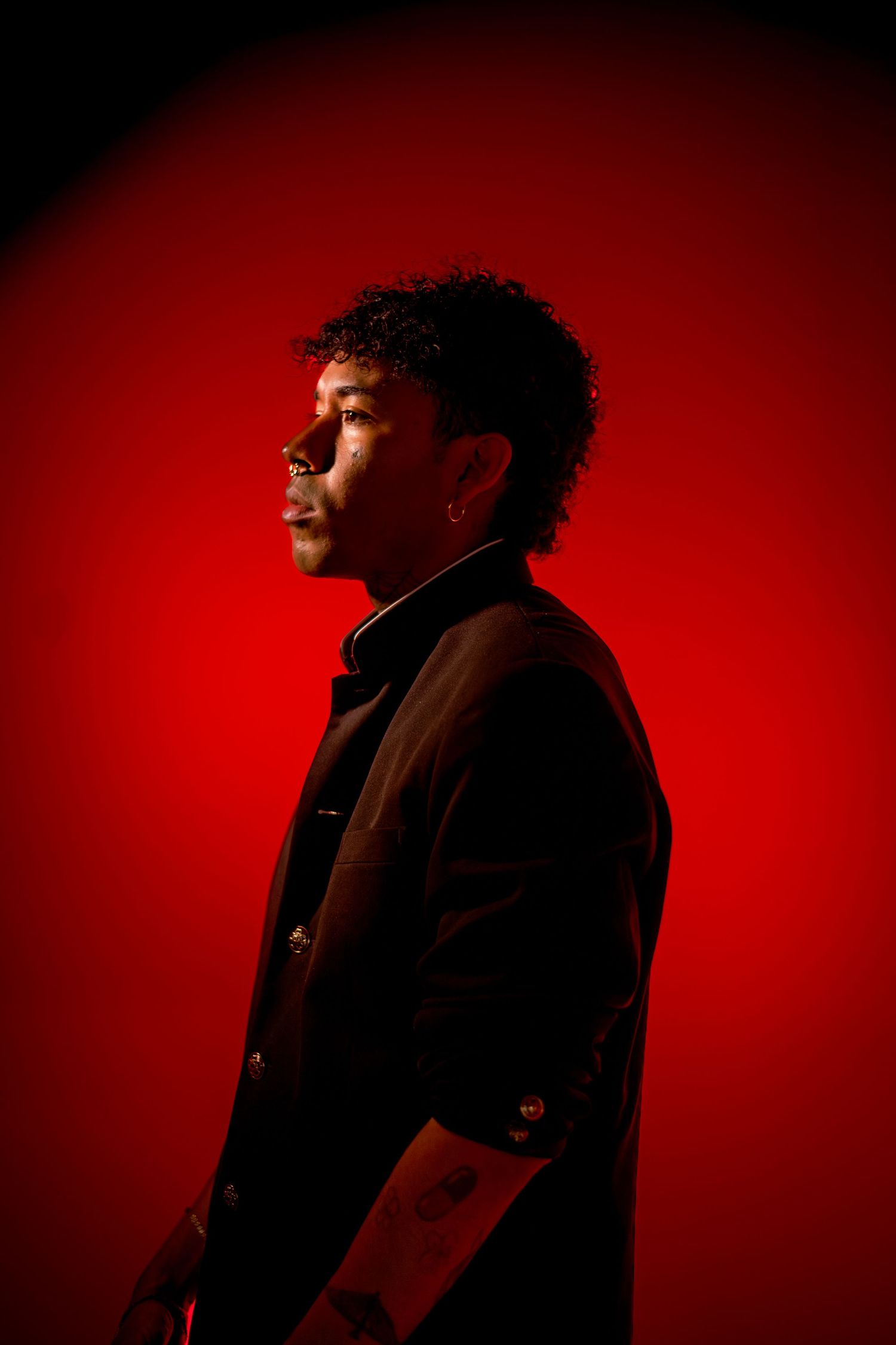 Dramatic portrait series with figure silhouetted against deep red background showing different profile angles.