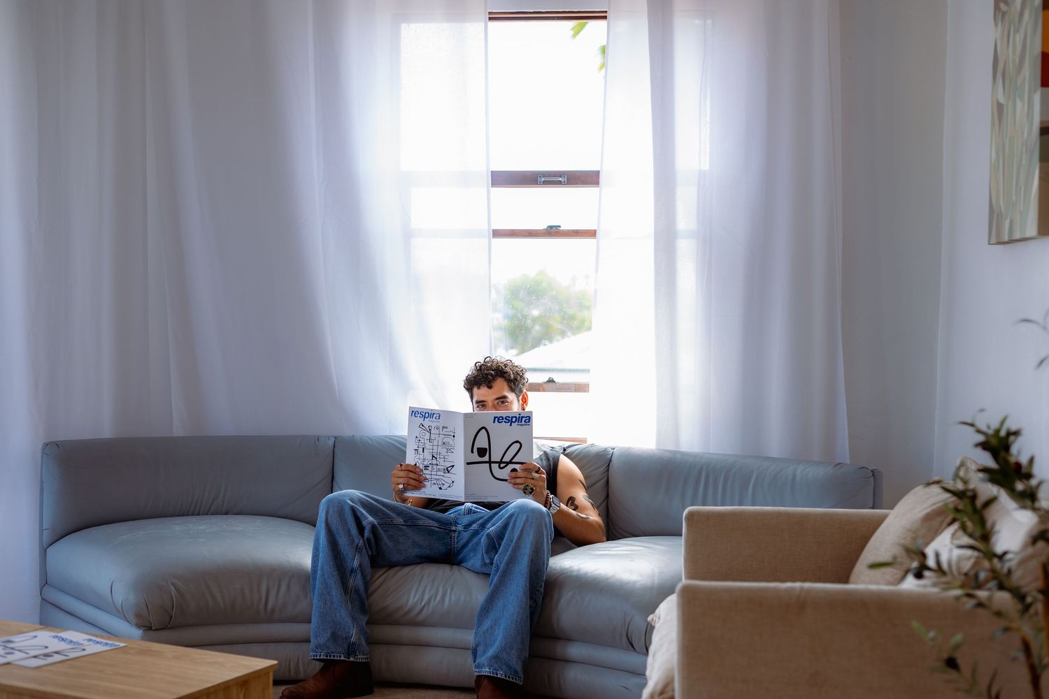 Minimalist interior scene showing a bright white room with windows and modern furniture.