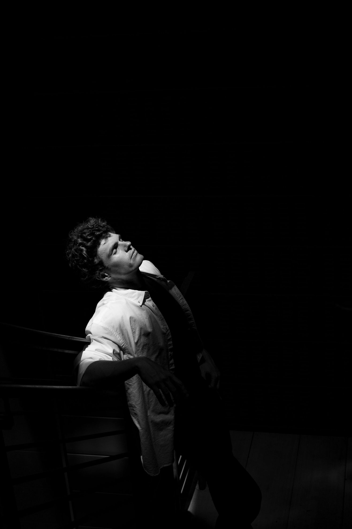 Dramatic black and white portrait series showing expressive poses in low key lighting.