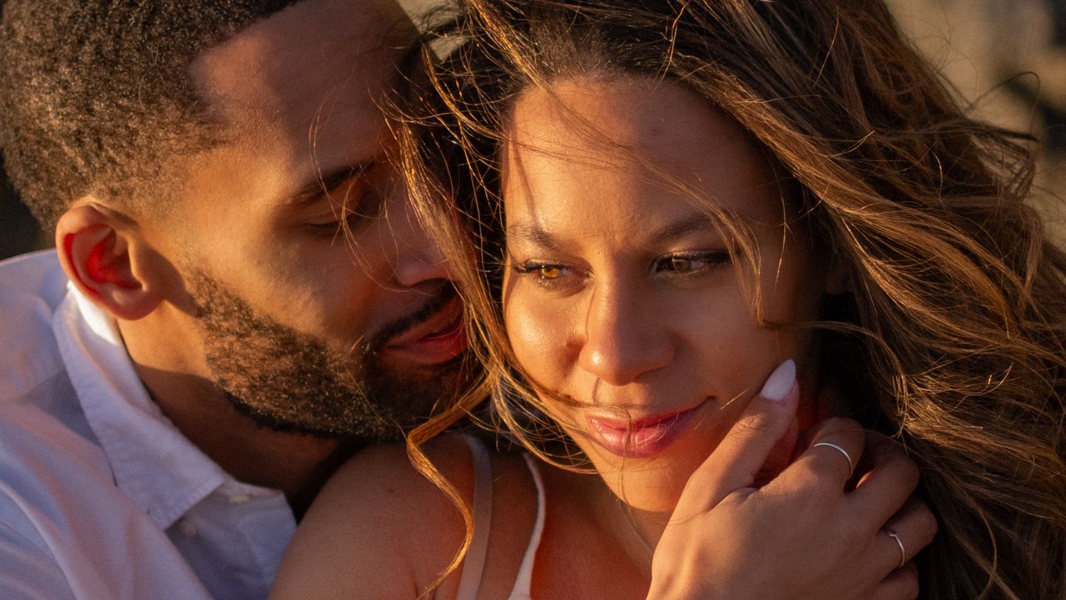 A series of romantic couples embracing and sharing intimate moments in warm sunlit settings.
