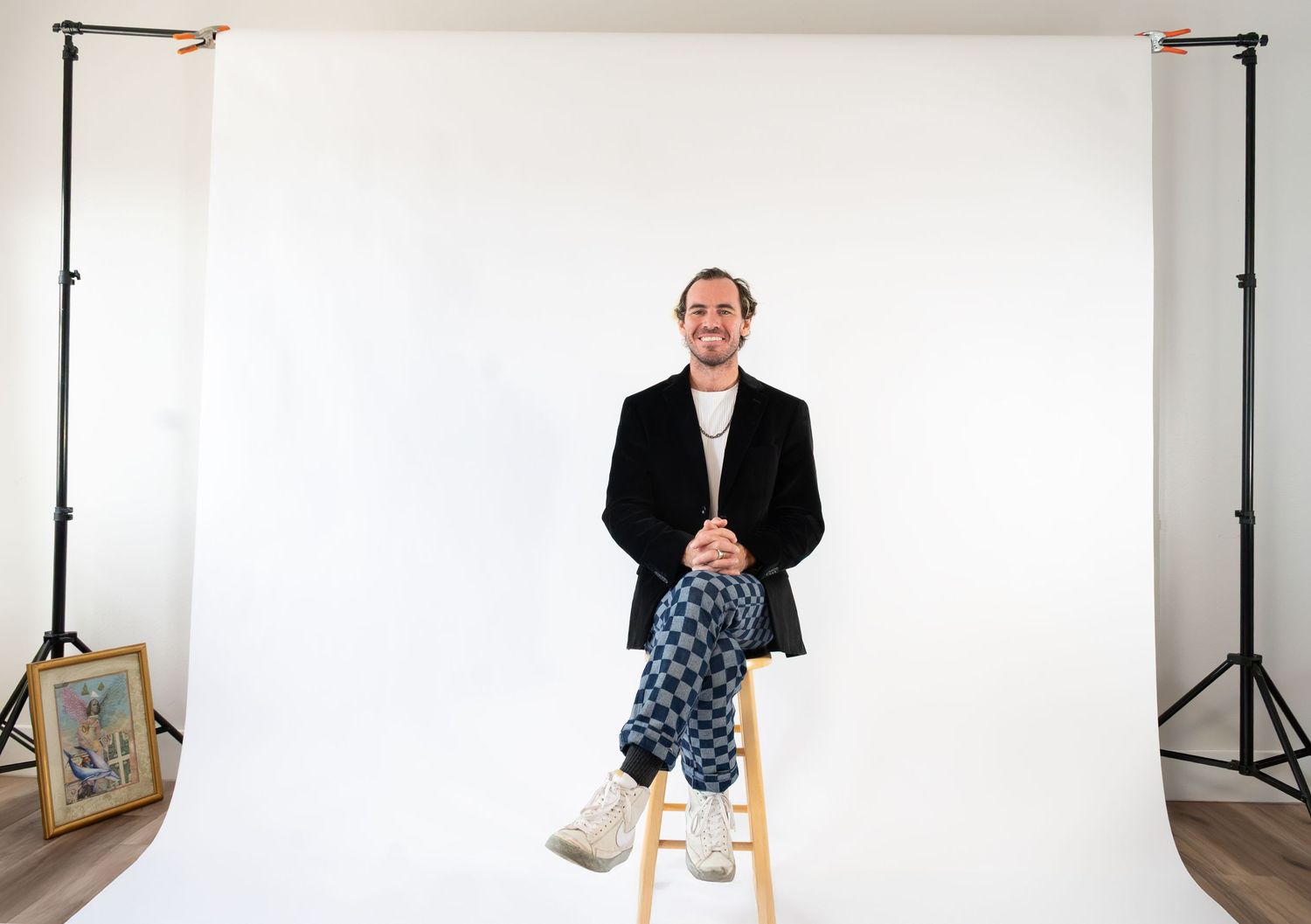 A sequence of fashion photography shots showing a model in business attire against a white backdrop.
