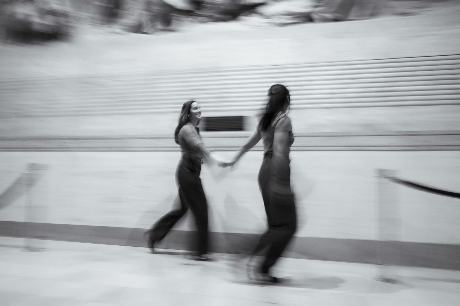 A sequence of black and white photographs showing dancers in motion on a stage with horizontal lines.